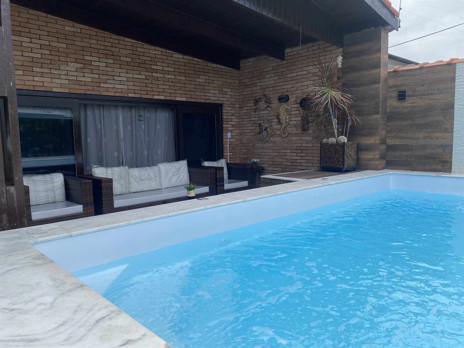 Área de piscina e convivência do Hostel Pé na Areia